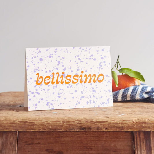 Greeting card with 'bellissimo' text on a wooden surface
